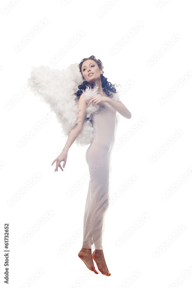 Charming curly brunette posing in angel costume Charming curly brunette posing in angel costume