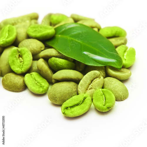 Green coffee beans with leaf on white background.