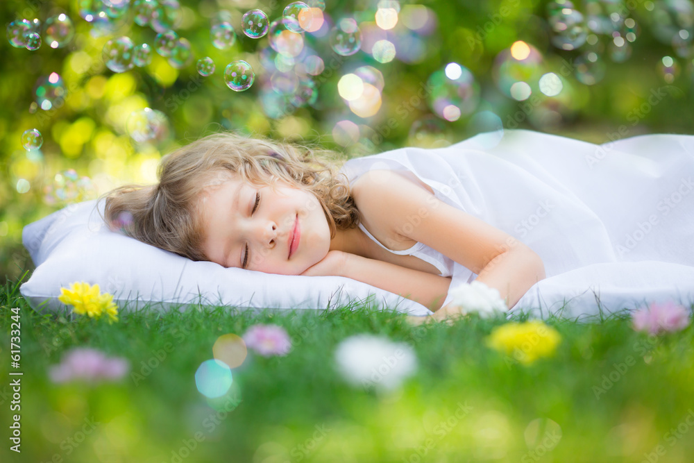 Kid sleeping in spring garden - obrazy, fototapety, plakaty 
