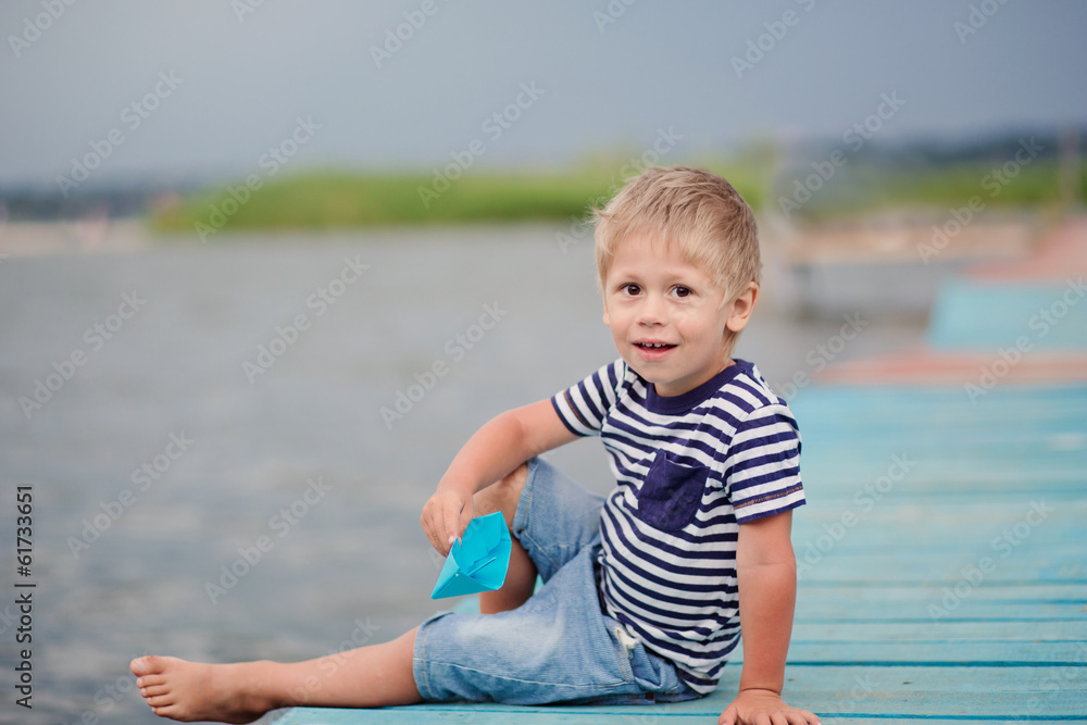boy of four on jetty by the sea boy of four on jetty by the sea