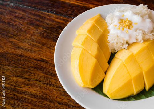 Thai style tropical dessert, glutinous rice eat with mangoes