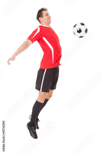 Professional soccer player kicking ball © Andrey Popov