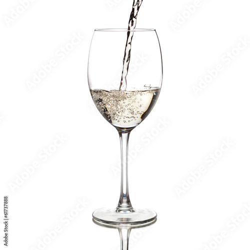 white wine pouring into a glass