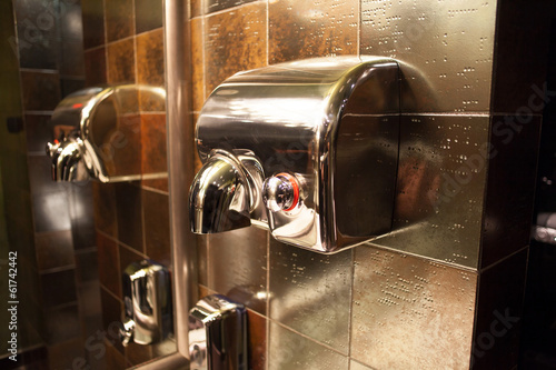 metal hand drier in public toilet