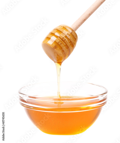 Bow of honey and wooden spoon.