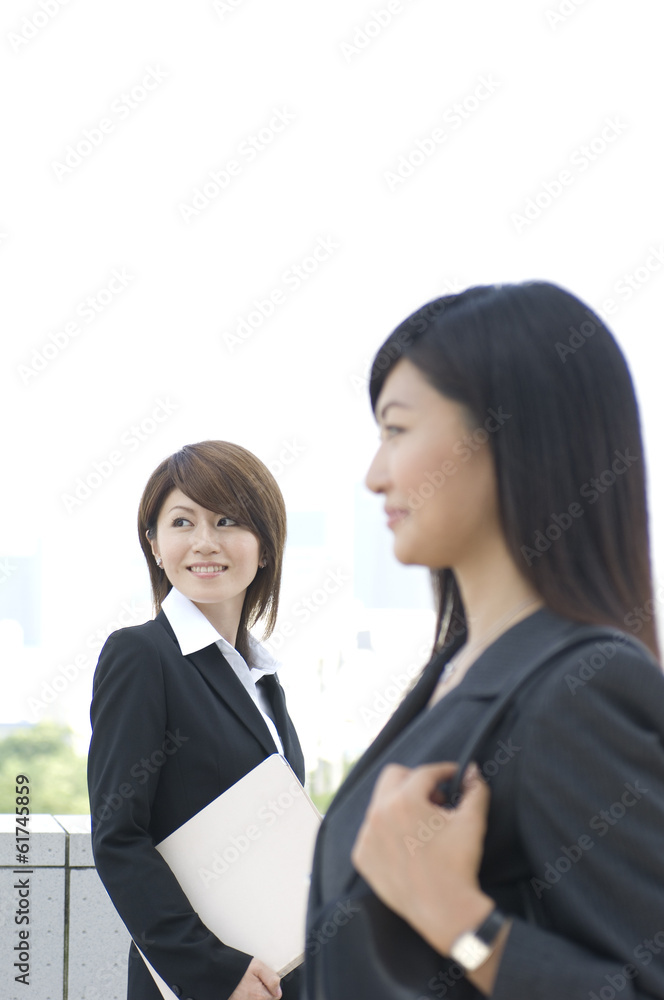 Two Japanese women in their twenties looking outside Two Japanese women in their twenties looking outside