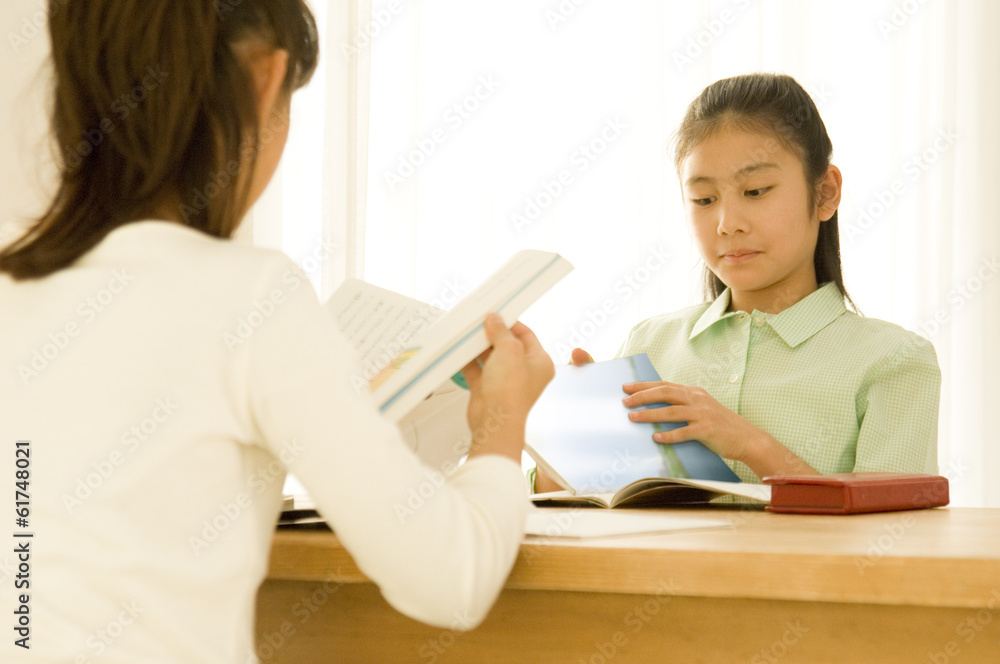 Two Japanese girls studying indoors Two Japanese girls studying indoors