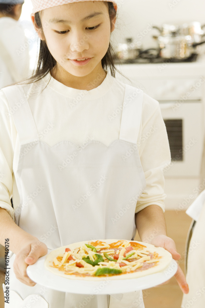 Japanese girl preparing for cooking in kitchen Japanese girl preparing for cooking in kitchen