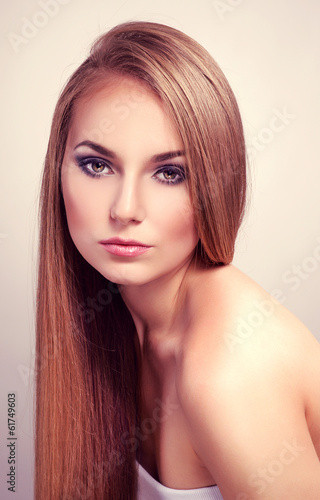Pretty fashion female model with long straight glossy hair