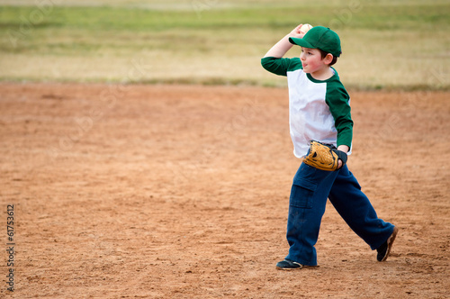 Boy throws baseball during practice