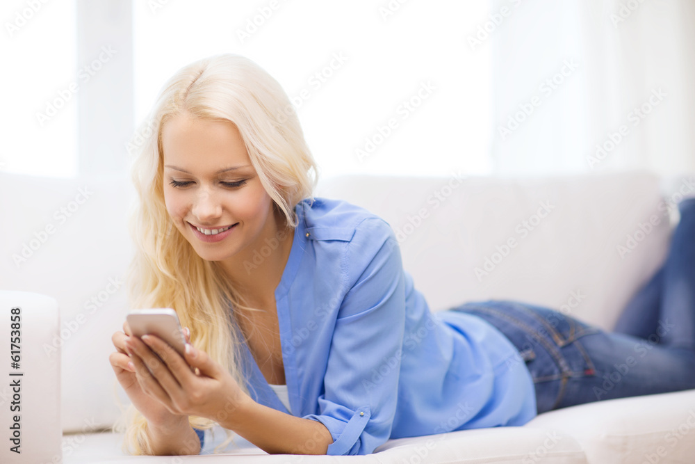 smiling woman with smartphone at home smiling woman with smartphone at home