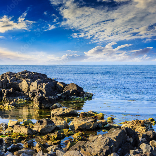 sea wave breaks about boulders