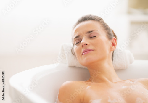 Fototapeta Relaxed young woman in bathtub