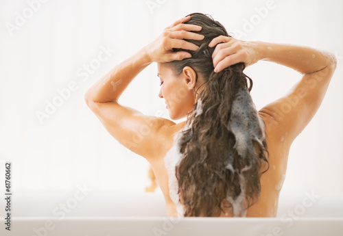 Young woman washing hair. rear view