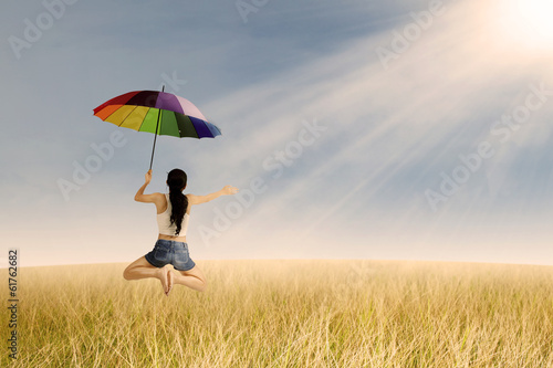 Woman jumps at rice field