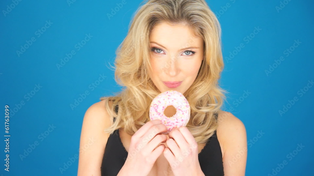 Beautiful blond woman eating a big doughnut Beautiful blond woman eating a big doughnut