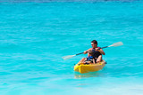 Father and son on a kayak ride in a tropical blue sea