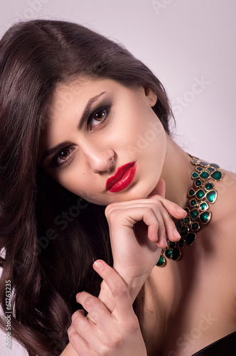 Portrait of beautiful young woman with makeup  with jewelry