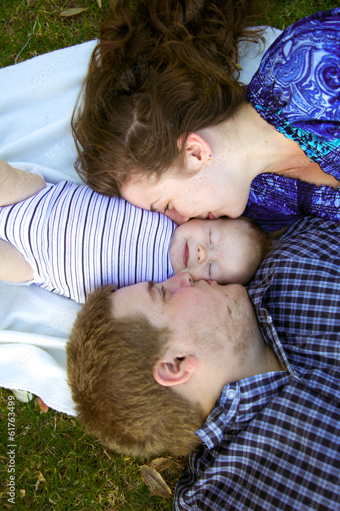Young parents with their baby at the park.