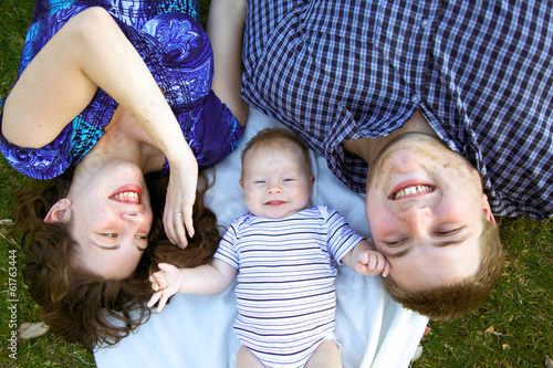 Young parents with their baby at the park.
