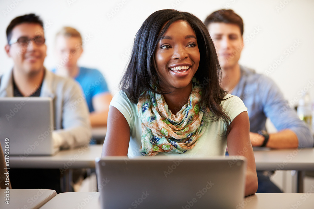 Female University Student Using Laptop In Classroom Female University Student Using Laptop In Classroom