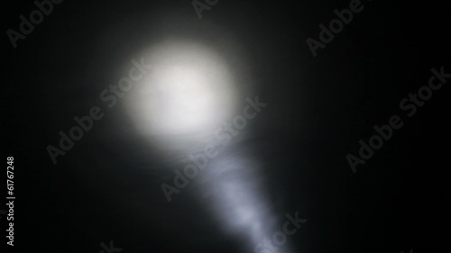 Moving spotlight in the hazy darkness, HD 1080p. photo