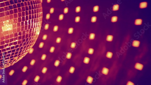 Part of purple disco ball effect and reflected dots on the wall