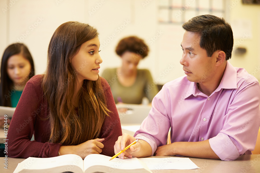 © Monkey Business - Female High School Student With Teacher Studying At Desk
