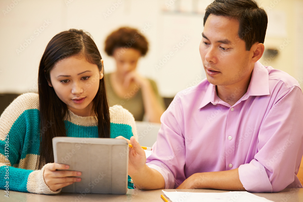 High School Student And Teacher Using Digital Tablet High School Student And Teacher Using Digital Tablet