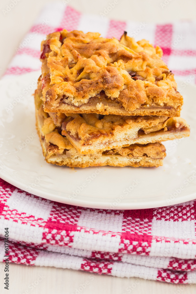 Slices of delicious fresh baked apple cake on a wooden surface Slices of delicious fresh baked apple cake on a wooden surface