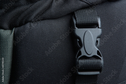 Black plastic buckle on backpack