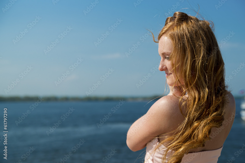 Beautiful young girl on river.