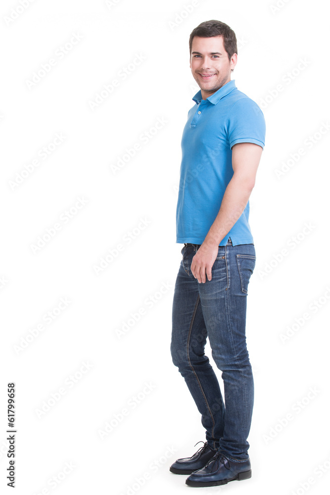 Full portrait of smiling happy handsome man in blue jeans. Full portrait of smiling happy handsome man in blue jeans.