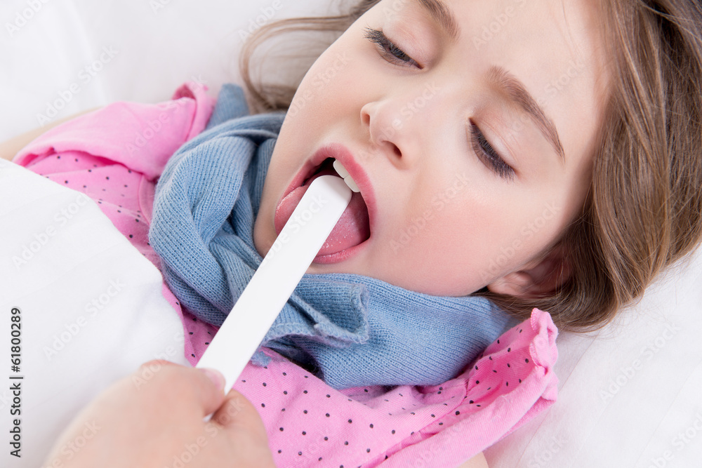 Pediatrician examining little girl's throat. Pediatrician examining little girl's throat.