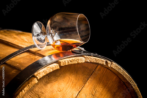 Glass of cognac on the vintage barrel
