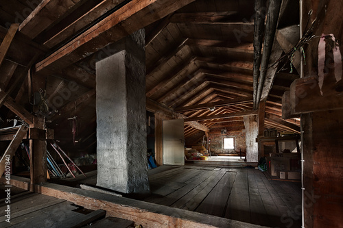 old wooden attic with roof framework structure and window photo