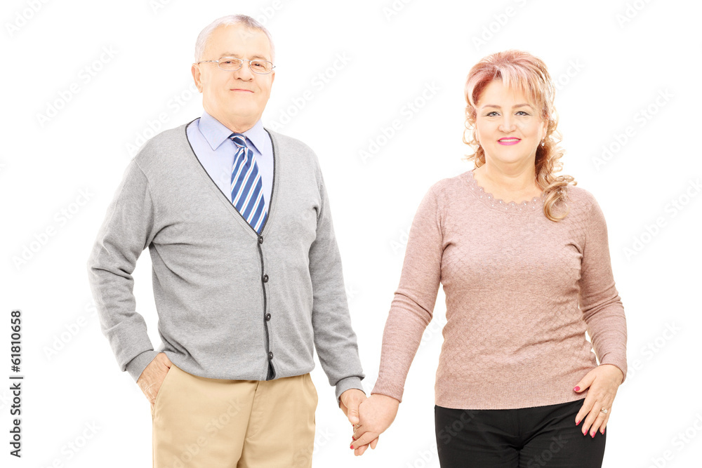 Middle aged couple holding hands and posing Middle aged couple holding hands and posing
