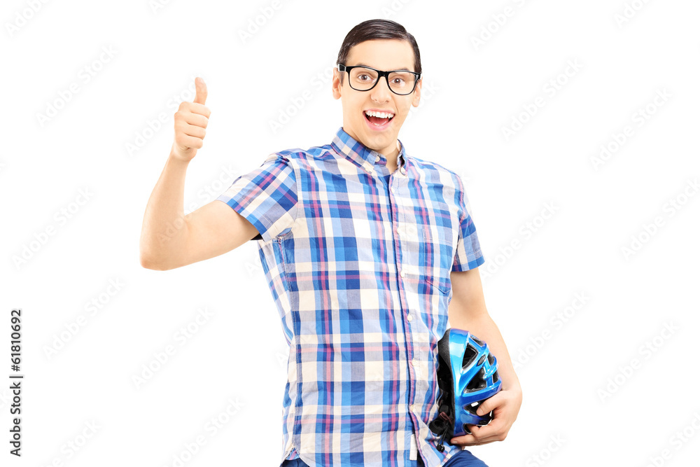Smiling guy standing holding helmet and giving thumb up Smiling guy standing holding helmet and giving thumb up