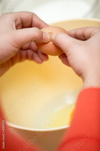 cook hands cracking eggs