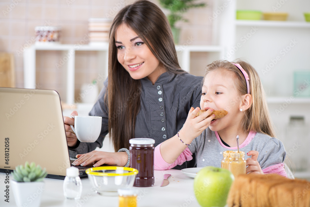 Businesswoman and her daughter breakfast