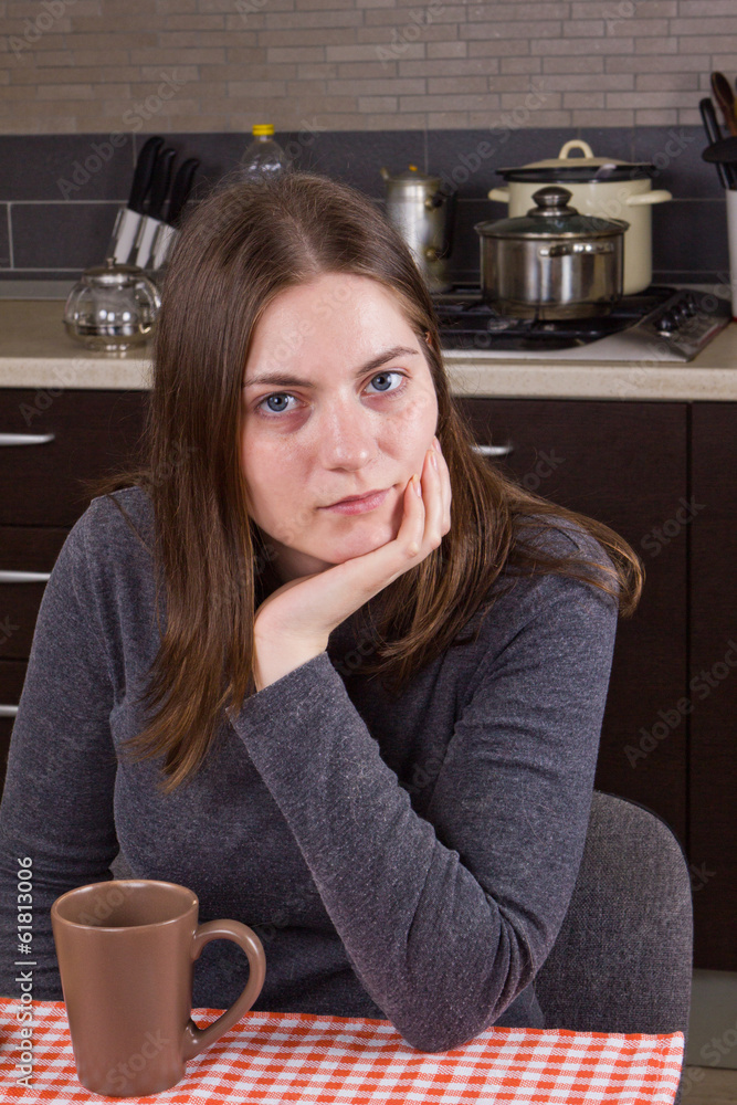Young girl drinking tea at kitchen Young girl drinking tea at kitchen