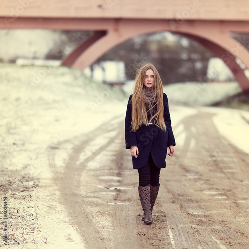Beautiful girl walking along a winter