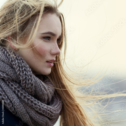 Portrait of beautiful girl in profile close-up in the wind