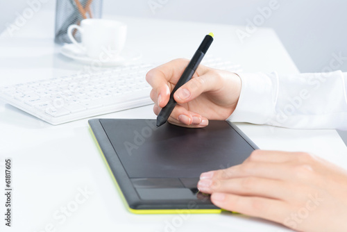 Designer hand drawing a graph on the tablet