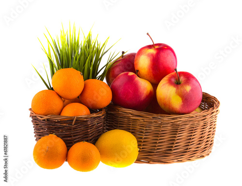 Red and yellow apples  tangerines and lemons in a wooden basket.