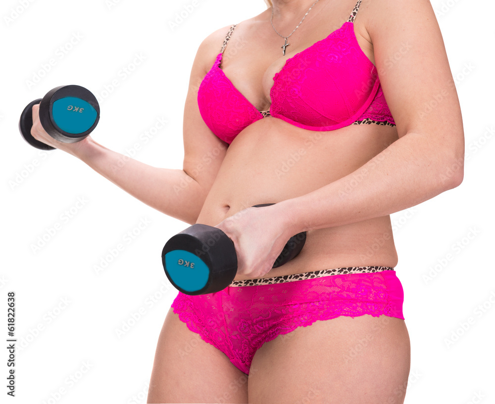 Obraz premium Overweight woman exercising with dumbbells