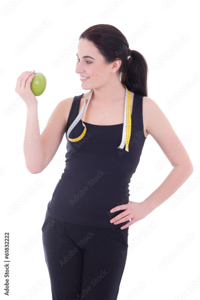 young attractive sporty woman with apple and measuring tape isol young attractive sporty woman with apple and measuring tape isol