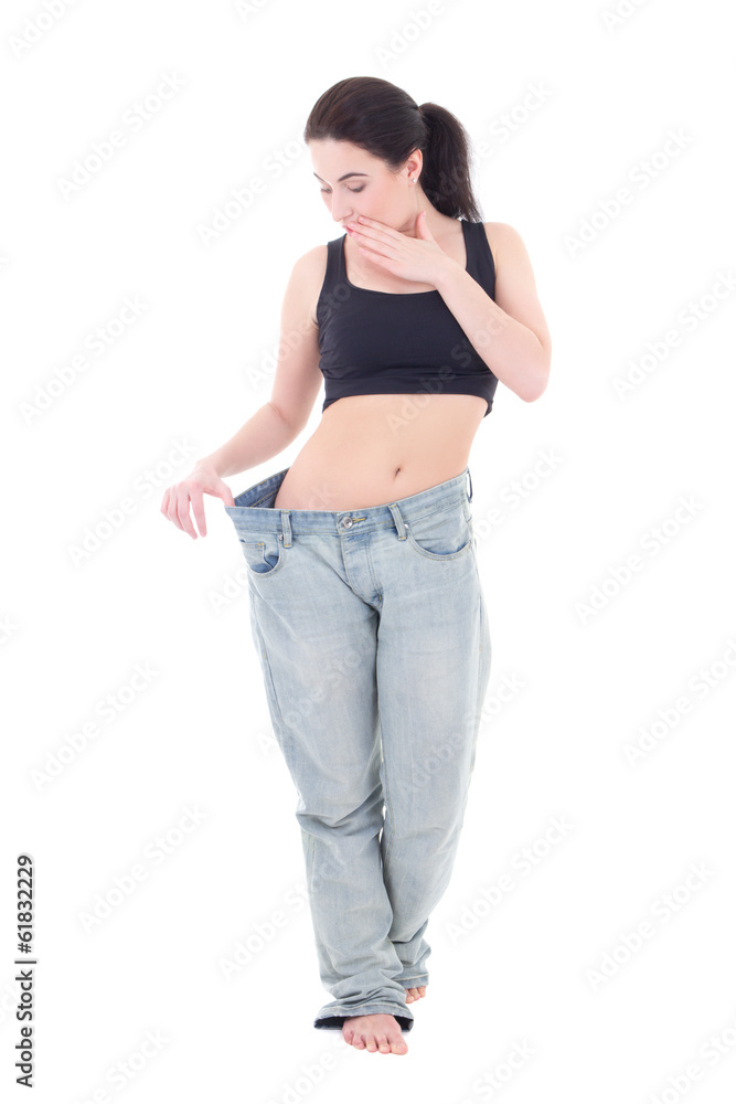 young beautiful slim excited woman in big jeans with isolated on young beautiful slim excited woman in big jeans with isolated on
