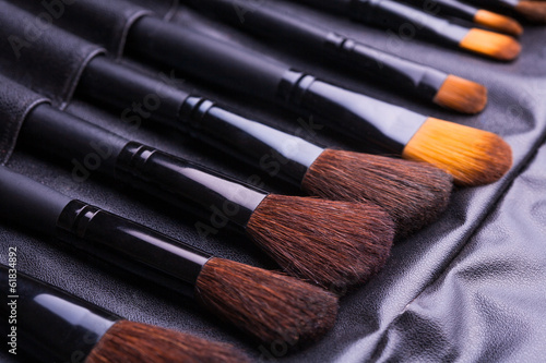 Set of black make-up brushes in row