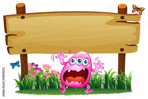 A scared pink monster under the wooden signboard